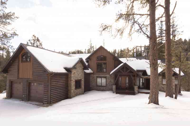 This home has some great variety in its siding choices: log siding, stone, barn wood board and baton siding.