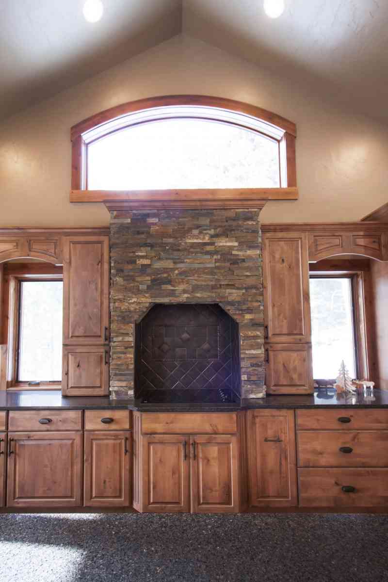 The stunning custom designed stone stove surround.