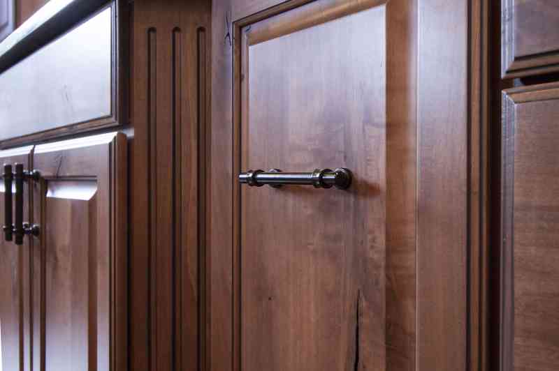 The oil-rubbed bronze kitchen cabinet pulls add a finishing touch to this rustic kitchen.