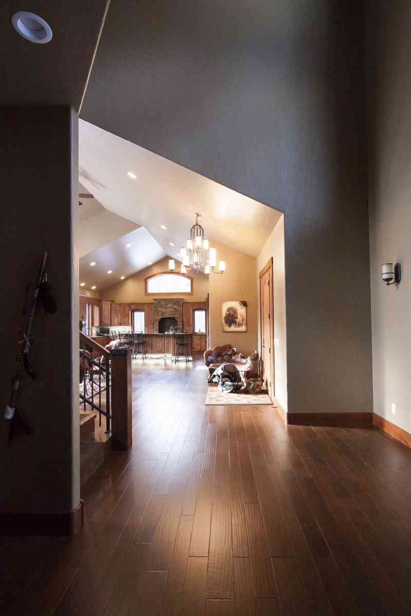 The entry door leads into the foyer followed by the open-concept living room and kitchen.