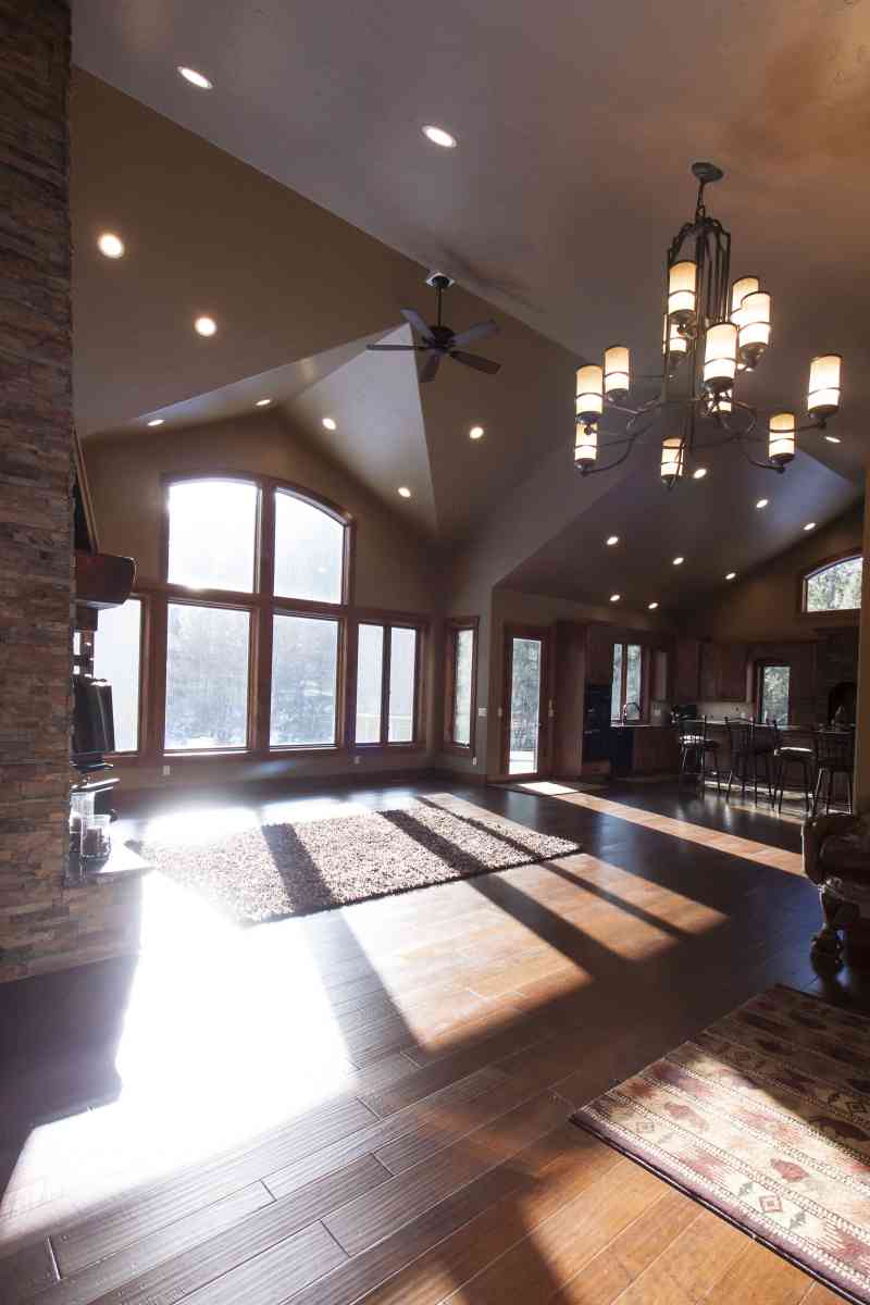 The large great room windows bring in a lot of light and are highlighted by custom-built arched trim.