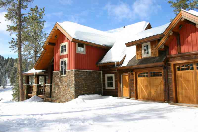 The shakes, triple fascias and garage doors all tie in with their honey-colored stain!