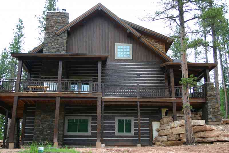A large stone chimney stretches from basement to roof.