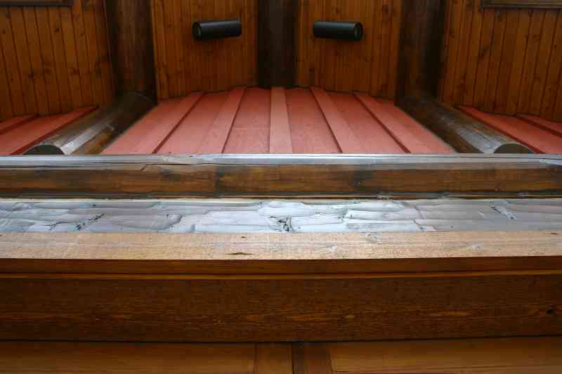 An upwards view of the gable-end lighting against the red barnwood.