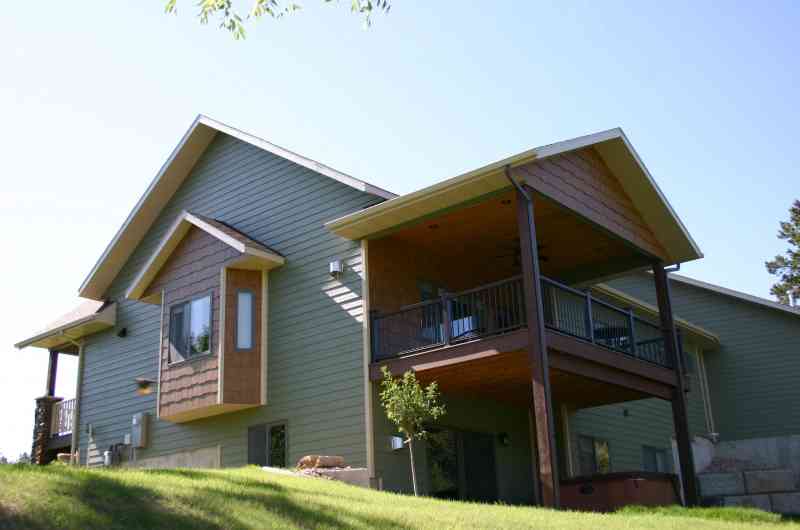 The back yard view of this home shows the various materials used.