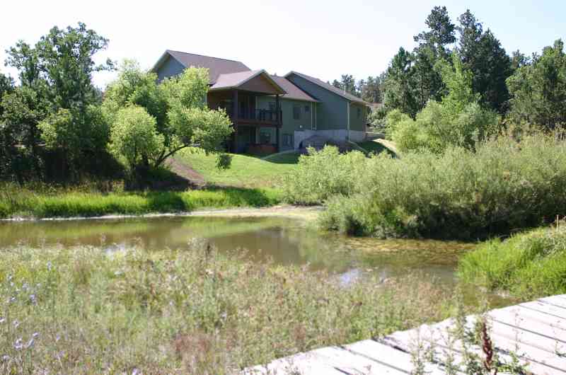 A beautiful backyard pond and bridge add charm to this country home!