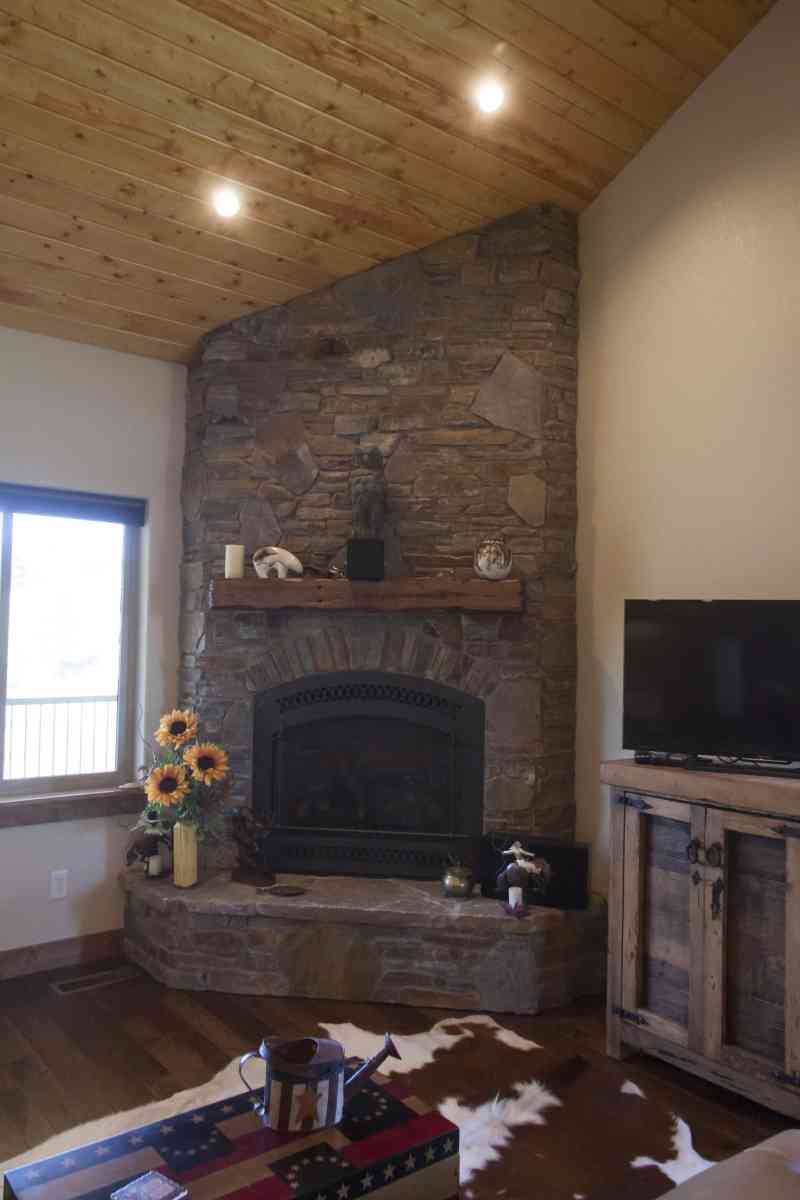 The rustic living room fireplace with a custom-made mantle.