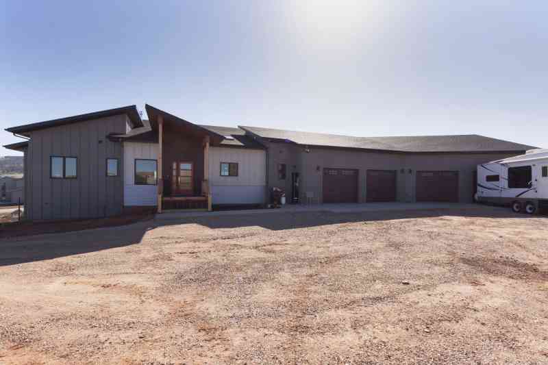 Several different materials were used to achieve this modern look: light and dark gray lap siding, board and baton siding, rusted metal and bare aluminum.