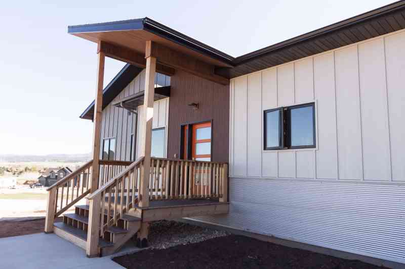 A side view of the dramatically slanted entry porch roof.