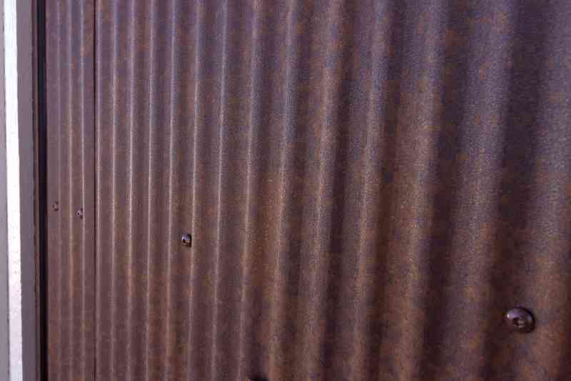 The Rustic Rawhide finished steel was used as siding and for decorative plates on the second story of this home.