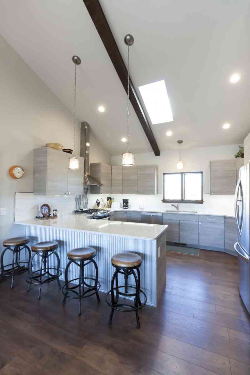 The kitchen island is complimented by trendy aluminum siding to match the exterior accents.