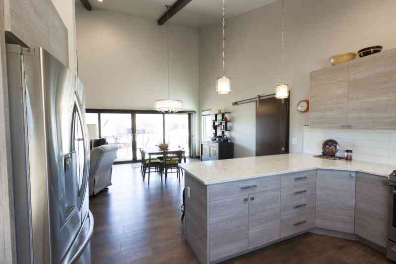 The kitchen opens up to the vaulted dining room and living room - what a grand ceiling!