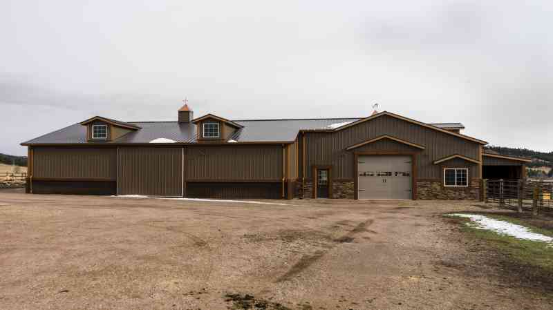 The back view showcases a large stable door and a sliding barn door.