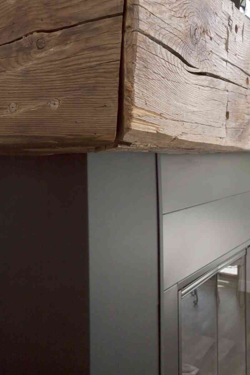 The textured metal and rough timber make a lovely contrast on the wood-burning fireplace.