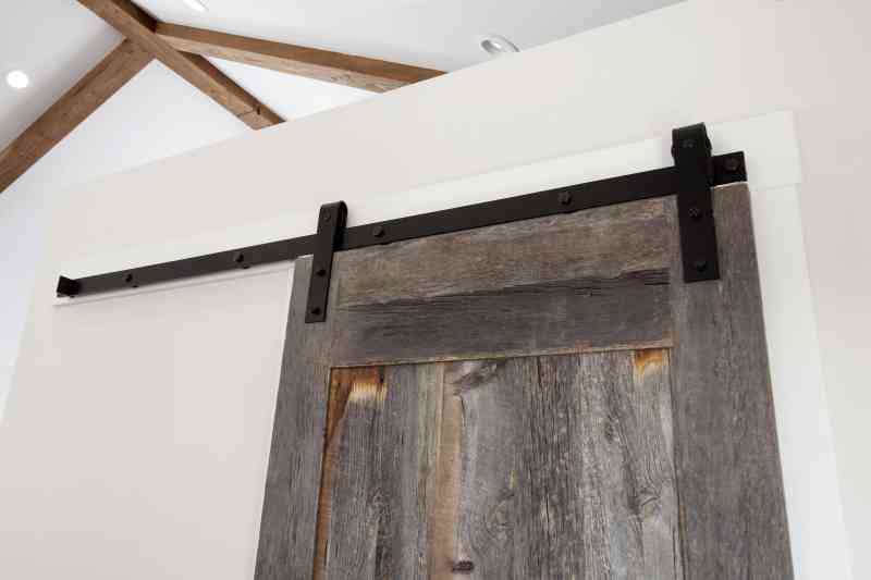 A custom-built, sliding barn door leading to the coat room.