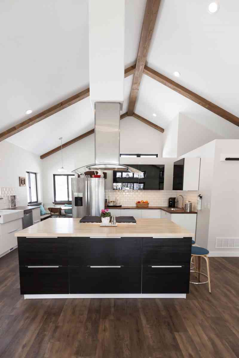 The Ikea kitchen cabinetry surrounding the large island and  cooktop area.