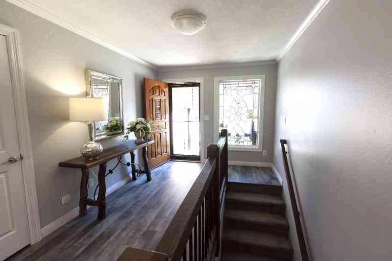 This entryway was brightened with an added window and mirror decor